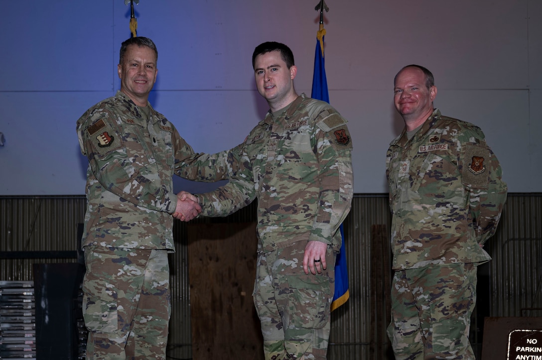 Lt. Col. Wilburn Poe, 28th Maintenance Group deputy commander and Chief Master Sgt. Daniel Werner, 37th Bomber Generation Squadron senior enlisted leader, recognize Senior Airman Stoney Jackson, 37th BGS technician, as Aircraft Avionics Technician of the Year at Grand Forks Air Force Base, N.D., April 25, 2025. There were approximately 37 awards presented during the ceremony, to acknowledge the 28th Bomb Wing airmen who went above and beyond while serving in maintenance roles 28th. (U.S. Air Force photo by Airman 1st Class Emma Funderburk)