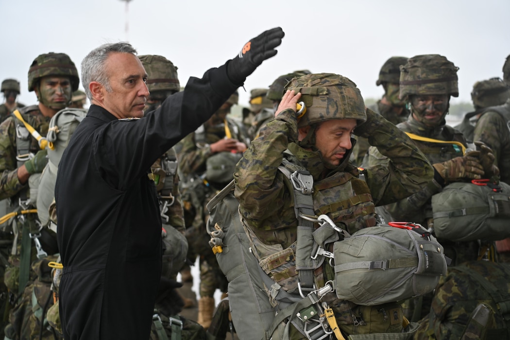 A Spanish Army paratrooper receives the signal to board a cargo plane during an exercise