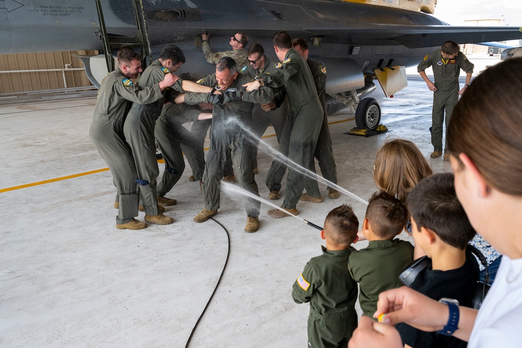 Pilot being sprayed by water