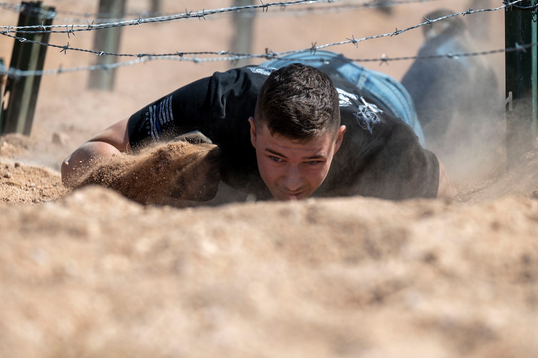 Airman crawling in dirt