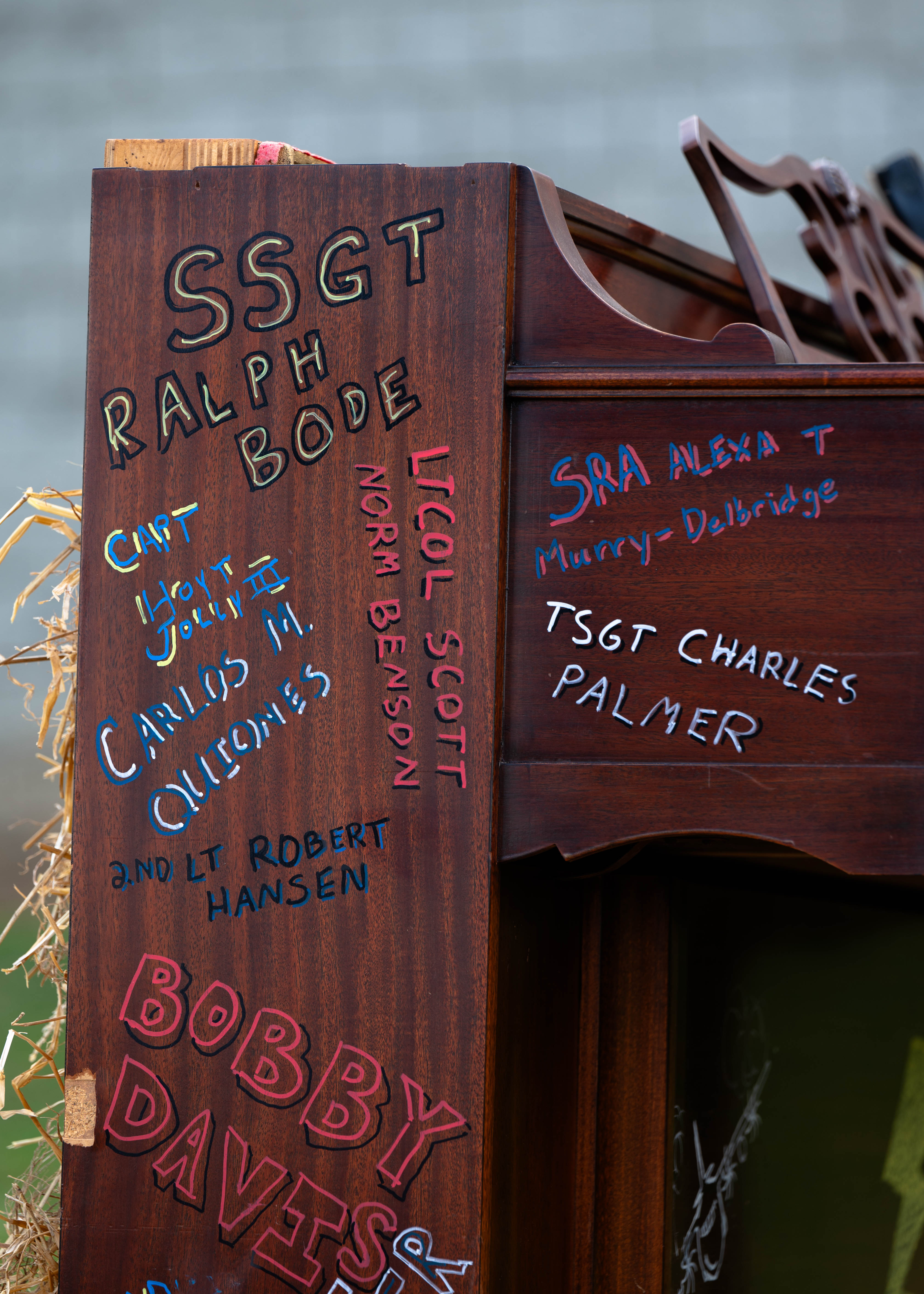 A piano inscribed with the names of Airmen burns during a ceremony hosted by the 700th Airlift Squadron at Dobbins Air Reserve Base, Ga., April 5, 2025. The tradition of piano burning serves as a solemn memorial to honor Airmen and their service. (U.S. Air Force photo by Master Sgt. Miles Wilson)