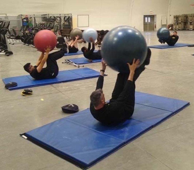 Soldiers in recovery use exercise balls in core class at the Fort Riley SRU.
