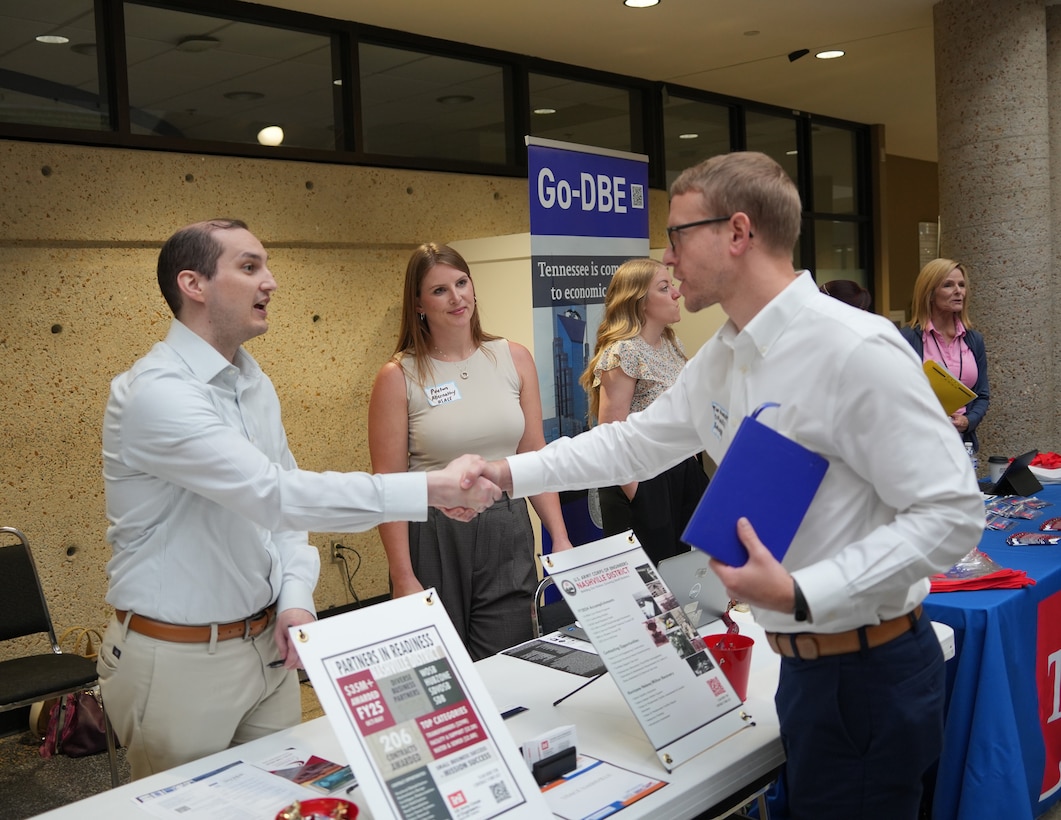 Andrew Roth, contracting officer for the U.S. Army Corps of Engineers Nashville District, greets a small business owner during the BIZGOV Connect event at Tennessee State University, May 20, 2025, in Nashville, Tenn., as Peyton Abernathy, civil engineer for the Nashville District, looks on. (USACE Photo by Noe Gonzalez)