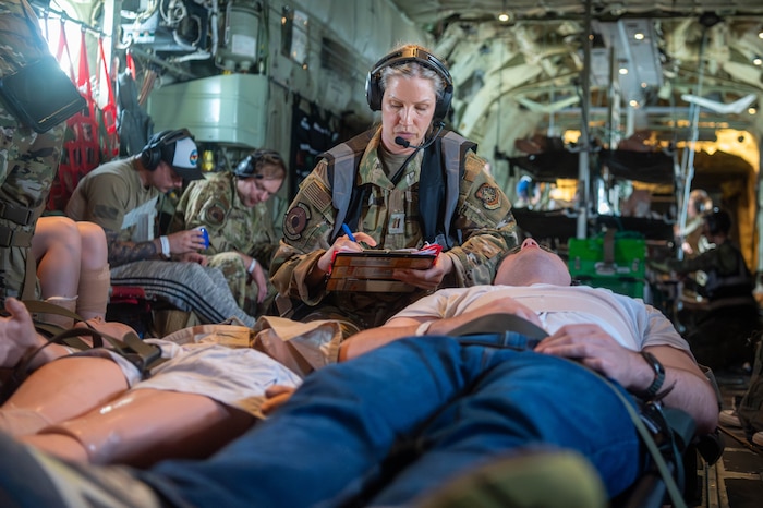 Air Force Capt. Stacie Elliot, 375th Aeromedical Evacuation Squadron flight nurse, documents injuries on a simulated casualty during a Theater Aeromedical Evacuation System exercise at Scott Air Force Base