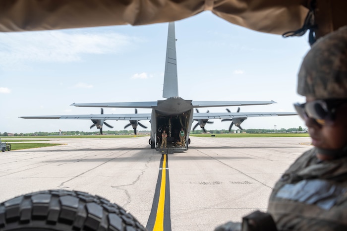 Airmen stand inside the open cargo bay of a C-130 Hercules during a Theater Aeromedical Evacuation System exercise at Scott Air Force Base