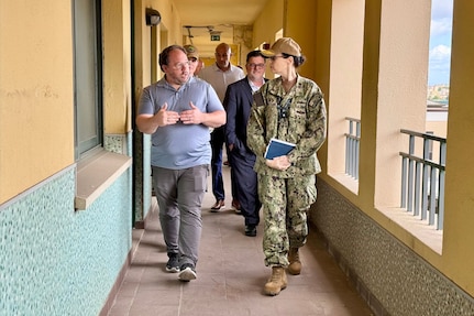 U.S. NAVAL SUPPORT ACTIVITY NAPLES, Italy – Rear Adm. Dianna Wolfson, U.S. Fleet Forces Command (USFFC) fleet maintenance officer, and Eric Lind, Commander, Navy Regional Maintenance Center (CNRMC) executive director, tour a facilities project with Jamie Watson, Forward Deployed Regional Maintenance Center (FDRMC) facilities director.