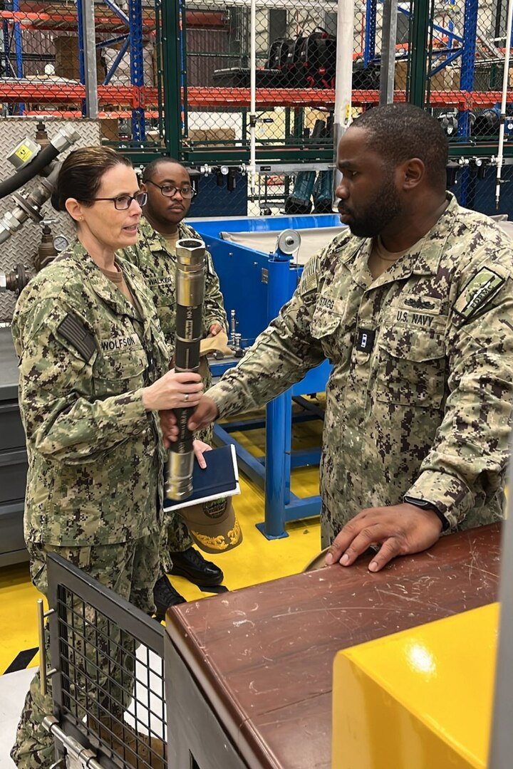 U.S. NAVAL SUPPORT ACTIVITY BAHRAIN – Rear Adm. Dianna Wolfson, U.S. Fleet Forces Command (USFFC) fleet maintenance officer, discuss intermediate-level maintenance capabilities with Forward Deployed Regional Maintenance Center Detachment Bahrain Repair Officer Chief Warrant Officer 4 Earl Stagg III.