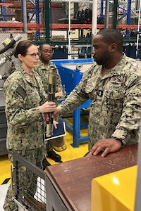 U.S. NAVAL SUPPORT ACTIVITY BAHRAIN – Rear Adm. Dianna Wolfson, U.S. Fleet Forces Command (USFFC) fleet maintenance officer, discuss intermediate-level maintenance capabilities with Forward Deployed Regional Maintenance Center Detachment Bahrain Repair Officer Chief Warrant Officer 4 Earl Stagg III.