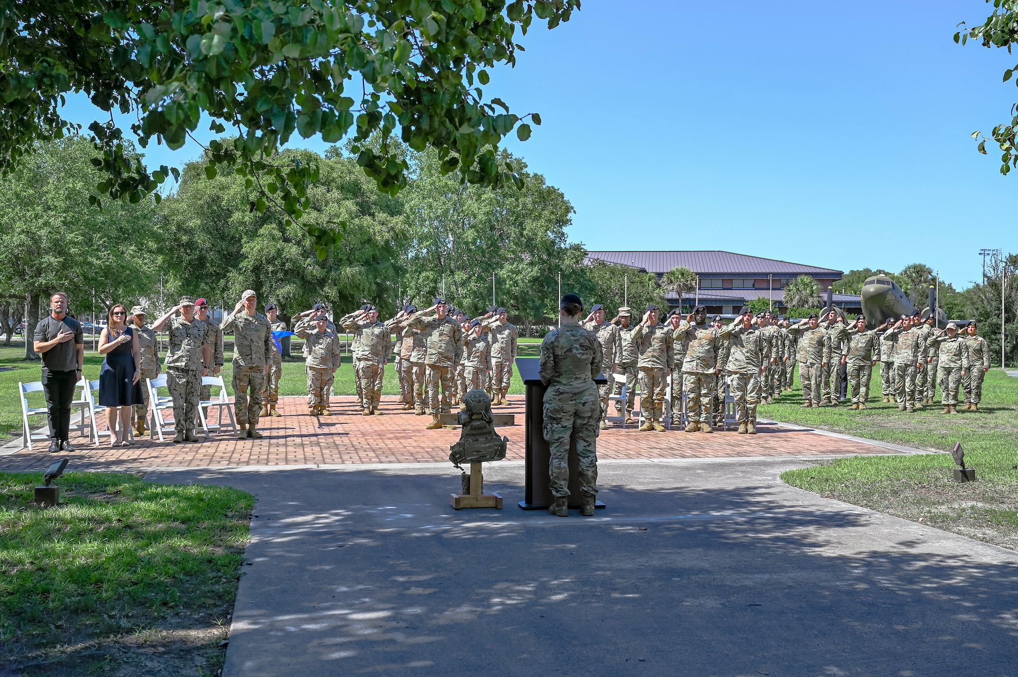 Joint Base Charleston leadership and Defenders from the 628th Security Forces Squadron render a salute during the National Anthem.