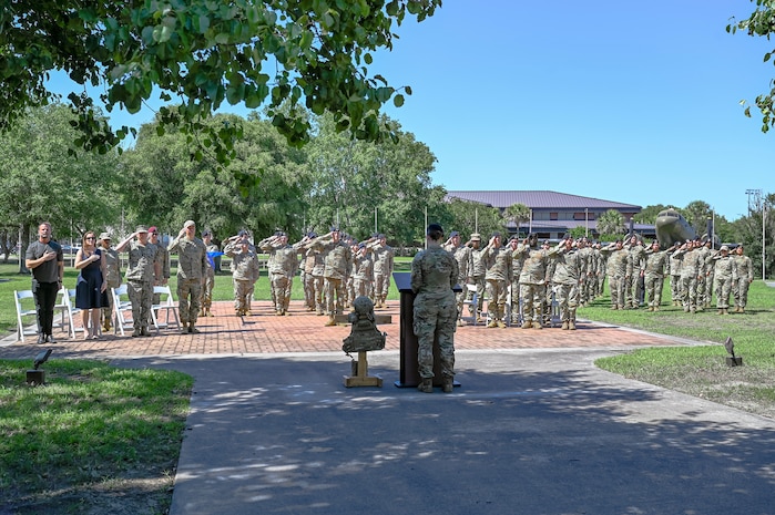 Joint Base Charleston leadership and Defenders from the 628th Security Forces Squadron render a salute during the National Anthem.