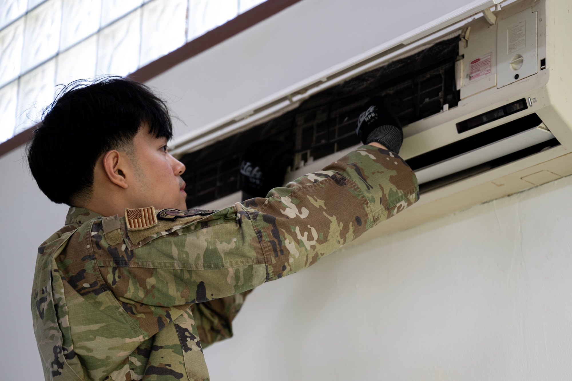 Senior Airman Lloyd Lu, 446th Civil Engineer Squadron, cleans an air conditioning unit at Moron Air Base, Spain, on May 6, 2025.