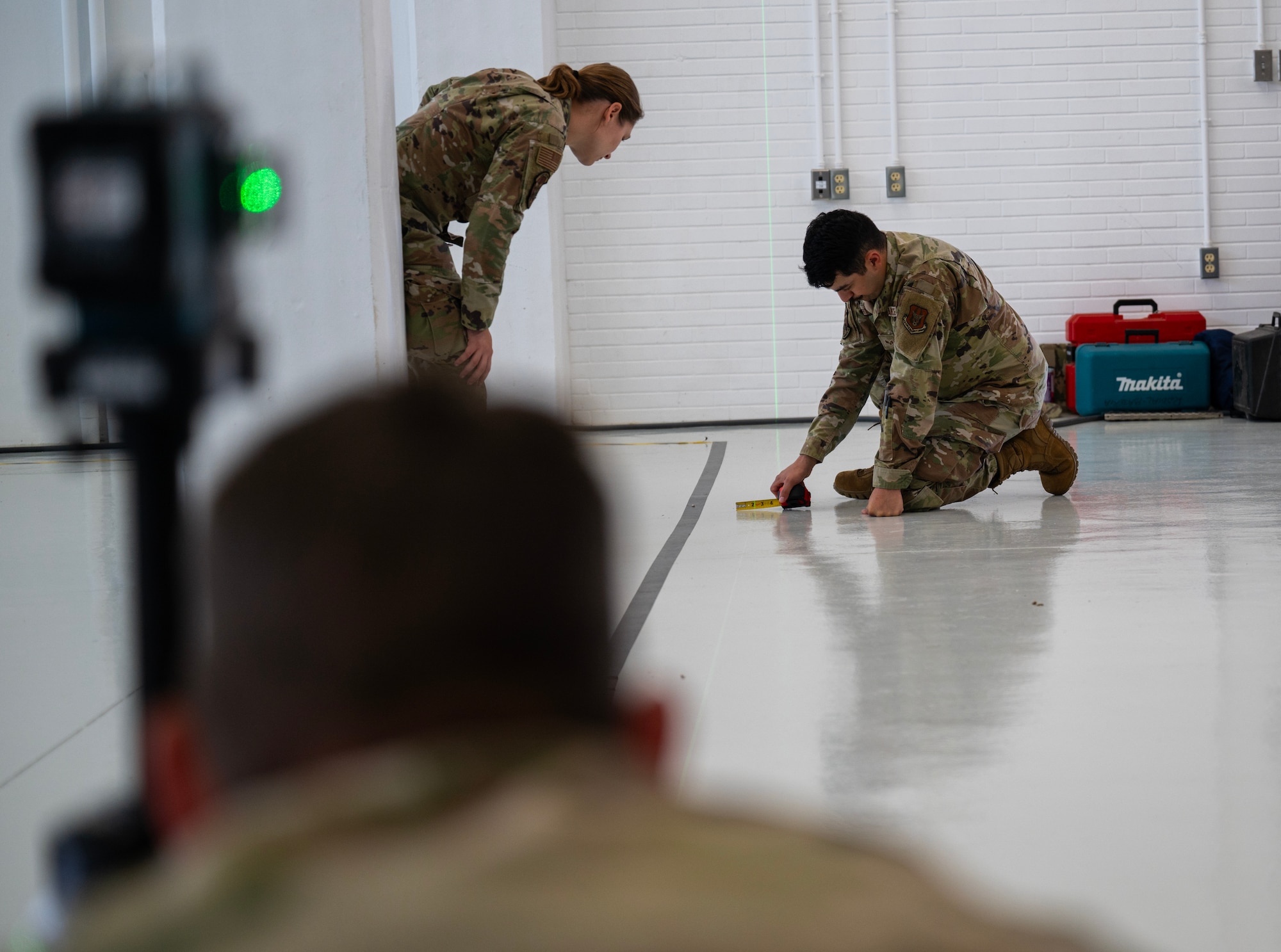 Senior Airmen Jessica Alcomendas and Eric Martinez-Pena, 446th Civil Engineer Squadron structural journeymen, take measurements at Moron Air Base, Spain, on May 6, 2025.