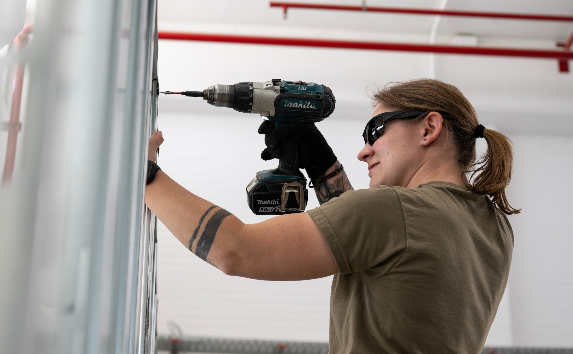 Senior Airman Jessica Alcomendas, 446th Civil Engineer Squadron structural assistant, screws frames together at Moron Air Base, Spain, on May 7, 2025.