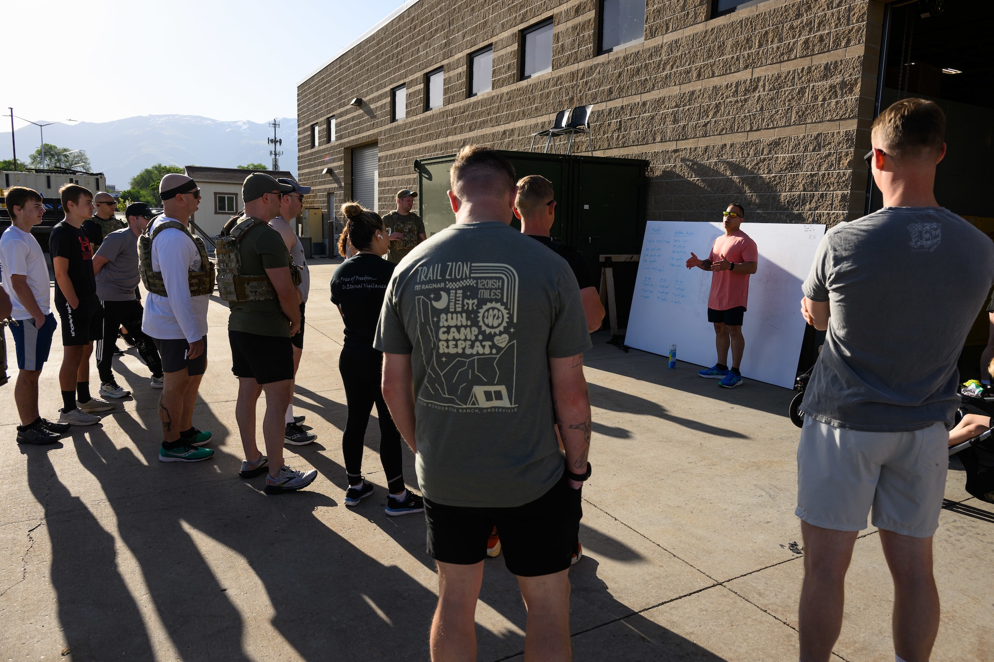 Staff Sgt. Jonathan Serrano, 75th Security Forces Squadron, briefs participants of a "Murph" workout at Hill Air Force Base, Utah, May 23, 2025. The "Murph" workout is commonly performed by military units, law enforcement agencies, and individuals around Memorial Day and throughout the year to honor the sacrifices of those who have served.  (U.S. Air Force photo by R. Nial Bradshaw)