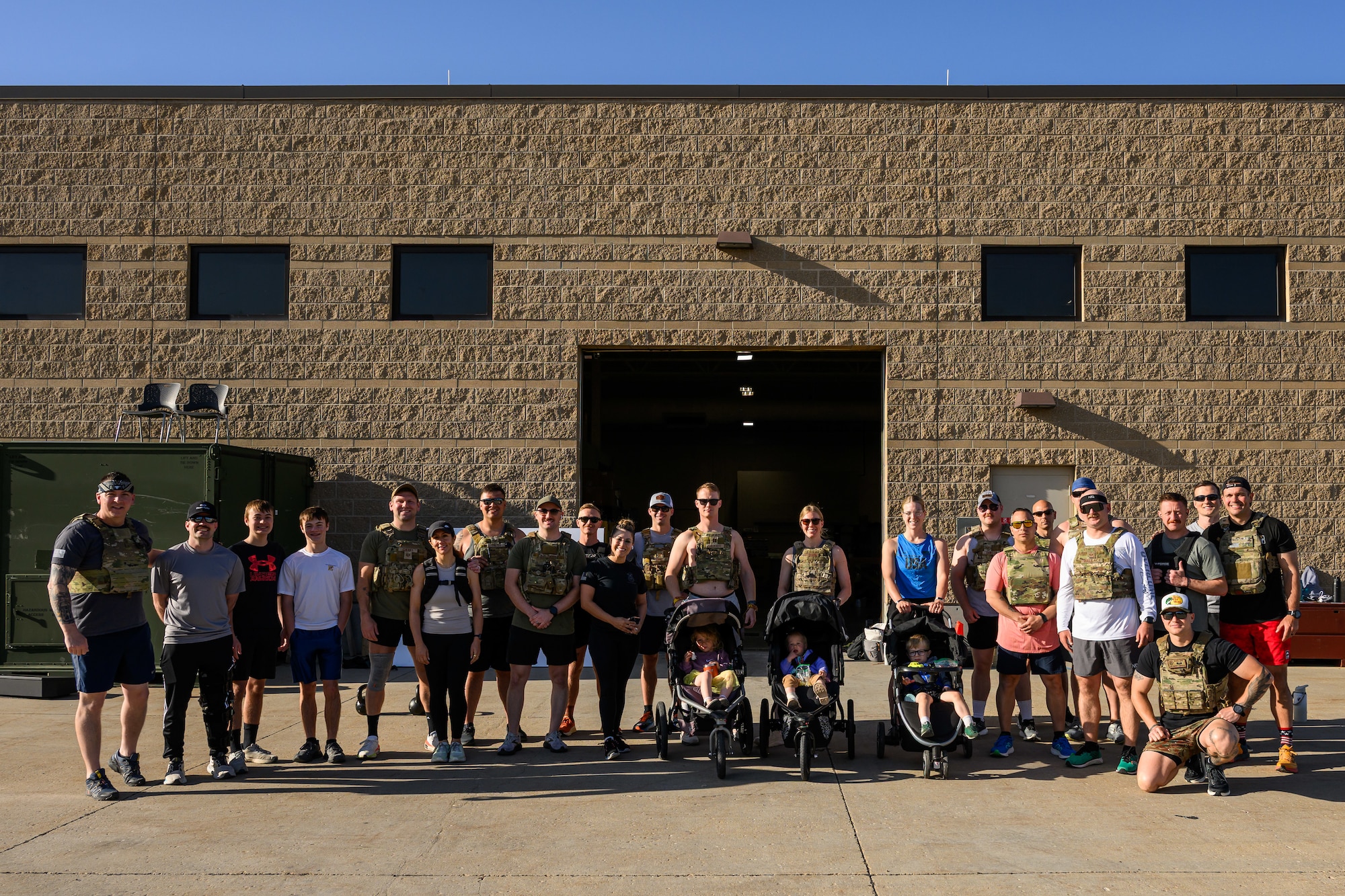 Participants of a "Murph" workout pose for a group photo at Hill Air Force Base, Utah, May 23, 2025. The "Murph" workout is commonly performed by military units, law enforcement agencies, and individuals around Memorial Day and throughout the year to honor the sacrifices of those who have served.  (U.S. Air Force photo by R. Nial Bradshaw)