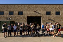 Participants of a "Murph" workout pose for a group photo at Hill Air Force Base, Utah, May 23, 2025. The "Murph" workout is commonly performed by military units, law enforcement agencies, and individuals around Memorial Day and throughout the year to honor the sacrifices of those who have served.  (U.S. Air Force photo by R. Nial Bradshaw)