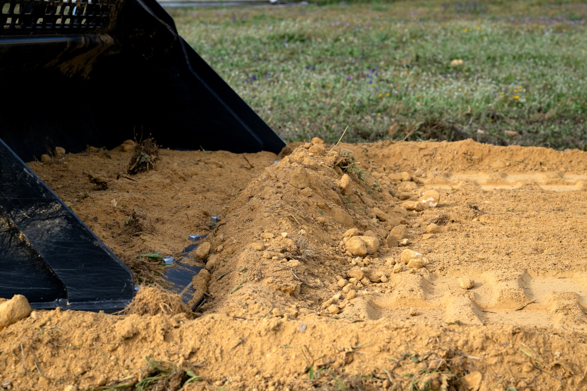 A bulldozer moves dirt to fix a natural running path at Moron Air Base, Spain, on May 7, 2025.