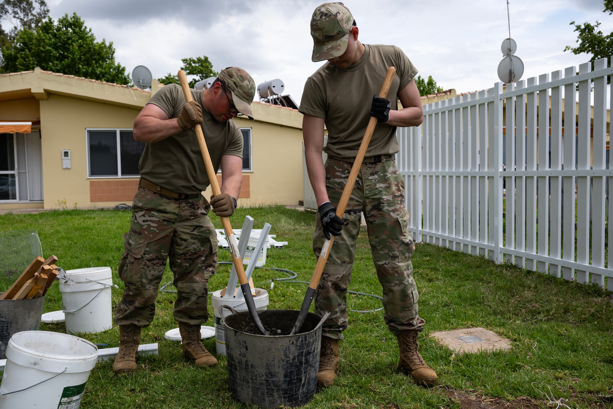 Senior Airmen Eric Mendez, 446th Civil Engineer Squadron pest management, and LLoyd Lu, 446th CES HVAC, mix concrete at Moron Air Base, Spain, on May 8, 2025.