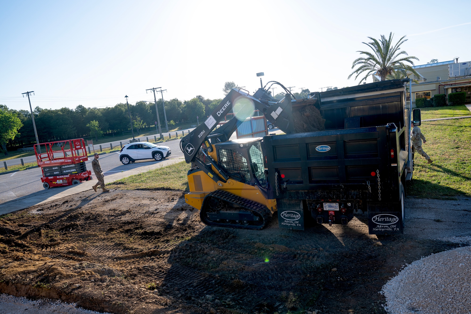 crawl loader dumps dirt into a truck bed at Moron Air Base, Spain, on May 6, 2025.