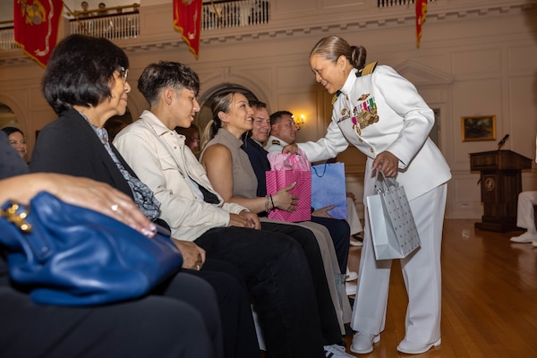 U.S. Navy Capt. Grace L. Key, outgoing commanding officer of Navy Medicine Readiness and Training Command Quantico, provides her family with gifts during a change of command ceremony at Harry Lee Hall on Marine Corps Base Quantico, Virginia, May 22, 2025. During the ceremony Key was relieved by Capt. Brookes Williams, incoming commanding officer of NMRTCQ. (U.S. Marine Corps Photo by Lance Cpl. Harleigh Faulk)