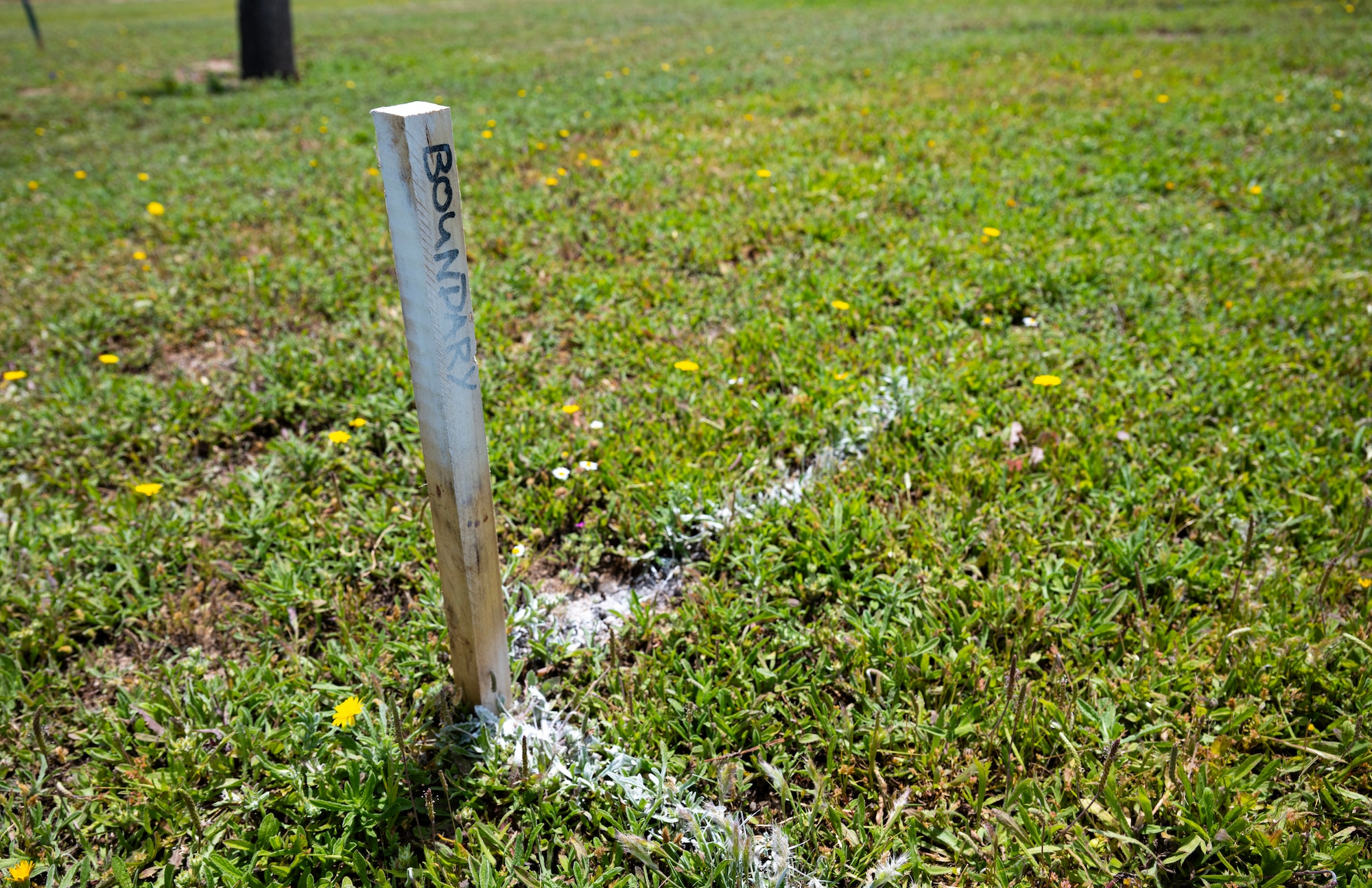 A stake lays in the ground in an open field at Moron Air Base, Spain, on May 12, 2025.