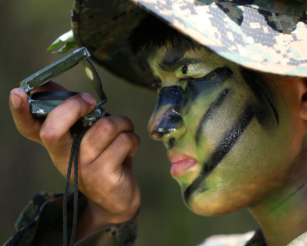 U.S. Marine Corps Lance Cpl. Troy T. Guiang, a rifleman with Guard Company, 2nd Platoon at Marine Barracks Washington, looks through a compass while conducting land navigation during a training exercise at Marine Corps Base Quantico, Virginia, April 22, 2025. This training exercise enabled Guard Co. Marines to rehearse effective communication, coordination, and preparation prior to movement. Marines at 8th & I conduct routine training to improve their cohesive precision, endurance and adaptability, skills that benefit the Marines on both the battlefield and parade deck.