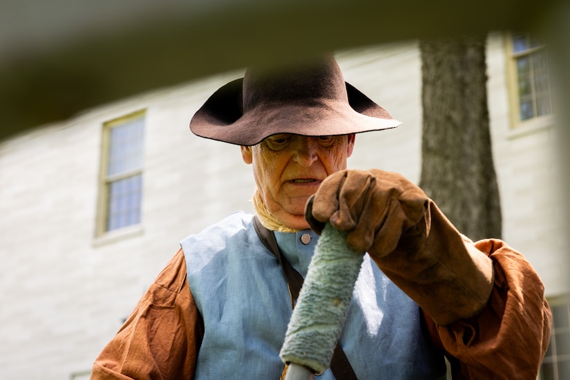 A Revolutionary War reenactor with the Painted Stones Settlers prepares to fire a cannon at the Kentucky Historical Society’s (KHS) 200th anniversary event at the Old State Capitol in Frankfort, Ky. on May 17, 2025. The Kentucky National Guard’s 202nd Army Band supported the 200th anniversary of the French officer Marquis de Lafayette’s visit of Frankfort which was coordinated by the KHS. (U.S. Army National Guard photo by Sgt. 1st Class Andrew Dickson)