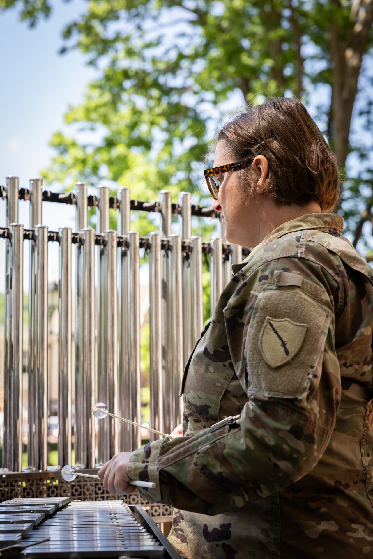 U.S. Army Sgt. Brittny Kempfer, a percussionist for the Kentucky National Guard’s 202nd Army Band, plays the bells at a concert at the Kentucky Historical Society’s (KHS) 200th anniversary event at the Old State Capitol in Frankfort, Ky. on May 17, 2025. The band supported the 200th anniversary of the French officer Marquis de Lafayette’s visit of Frankfort which was coordinated by the KHS. (U.S. Army National Guard photo by Sgt. 1st Class Andrew Dickson)