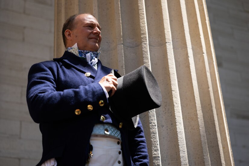 Mr. Michael Halbert, a professional Marquis de Lafayette actor, holds his top hat over his heart during the playing of the National Anthem by the Kentucky National Guard’s 202nd Army Band at the Kentucky Historical Society’s (KHS) 200th anniversary event at the Old State Capitol in Frankfort, Ky., on May 17, 2025. The Kentucky National Guard’s 202nd Army Band supported the 200th anniversary of the French officer Marquis de Lafayette’s visit of Frankfort which was coordinated by the KHS. (U.S. Army National Guard photo by Sgt. 1st Class Andrew Dickson)