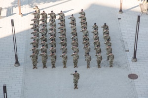 Members of the 316th Security Forces Group salute during the playing of the national anthem at the National Police Week opening ceremony  at Joint Base Andrews, Md., May 12, 2025. Established in 1962, National Police Week is an annual observance that honors local, state, and federal law enforcement officers who have died in the line of duty. (U.S. Air Force photo by Patrick Griffith)