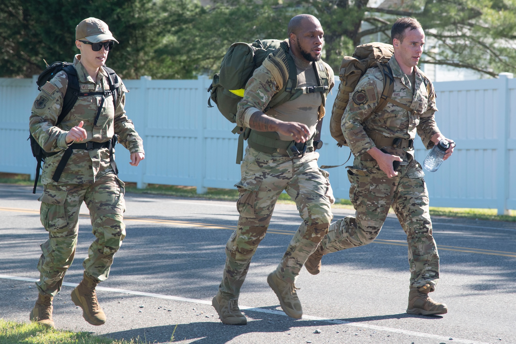 U.S. Airmen run during the Fallen Defender Ruck at Joint Base Andrews, Md., May 12, 2025. The event was part of activities on base commemorating National Police Week, which was established in 1962 to honor local, state, and federal law enforcement officers who died in the line of duty. (U.S. Air Force photo by Patrick Griffith)