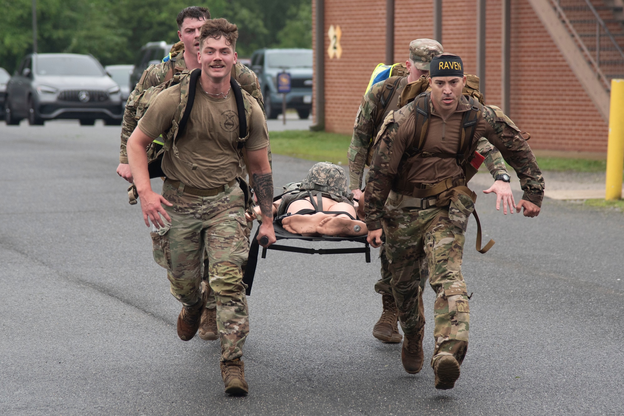 Defenders from the 316th Security Forces Group carry a training dummy on a litter to the final checkpoint during the Warrior Challenge at Joint Base Andrews, Md., May 14, 2025. The event was held in recognition of National Police Week. (U.S. Air Force photo by Patrick Griffith)