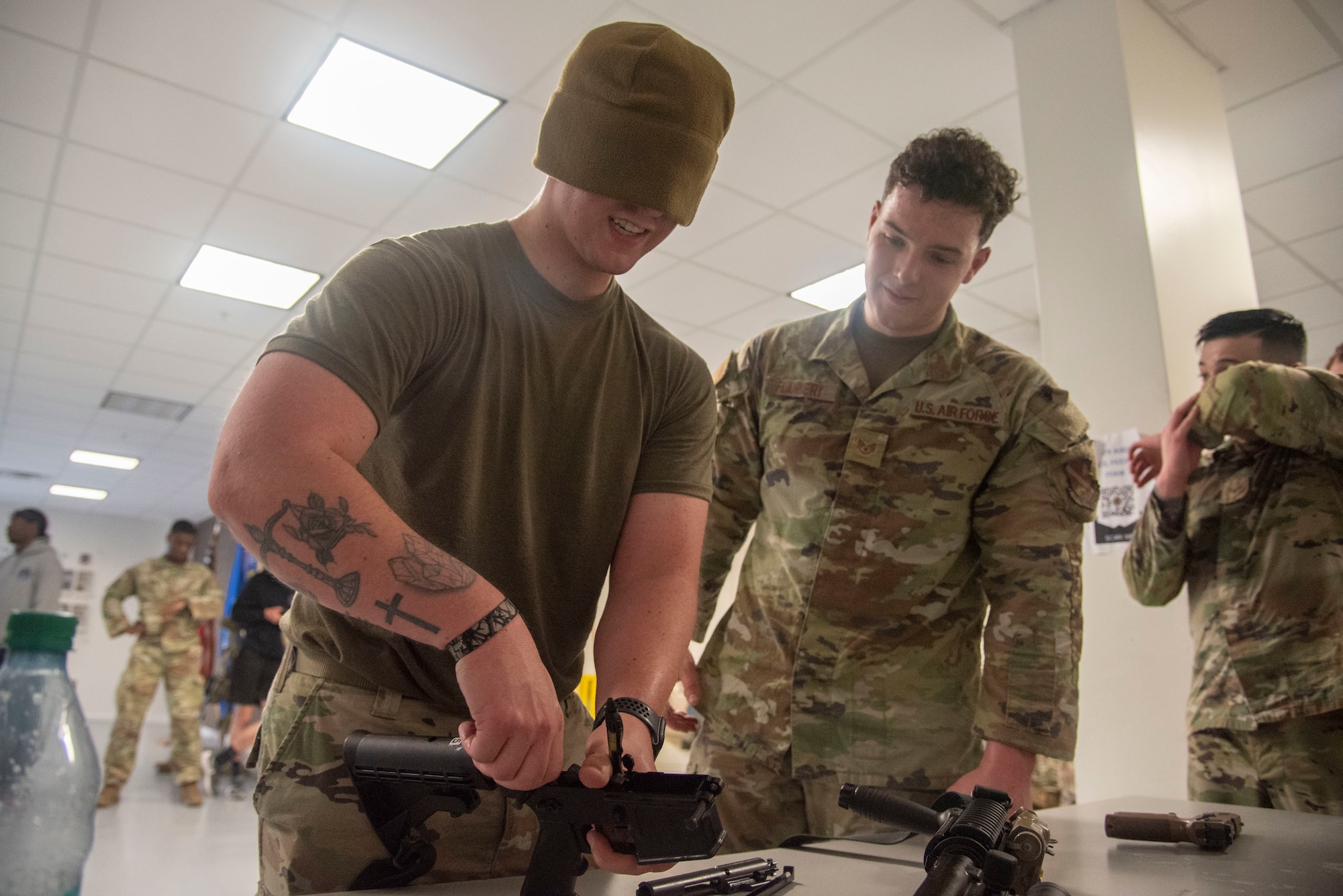 U.S. Air Force Staff Sgt. Christopher J. Horton, 816th Security Forces Squadron, disassembles an M-16 while blindfolded with assistance from Staff Sgt. Darrell P. Flannery, 816th SFS, at Joint Base Andrews, Md., May 14, 2025. The two were part of a four-person team that competed in the Warrior Challenge at Andrews honoring military police and security forces for National Police Week. (U.S. Air Force photo by Patrick Griffith)