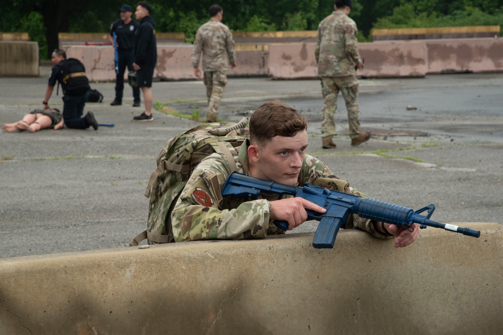 U.S. Air Force Airman 1st Class Ethan P. Robinson, 11th Security Forces Squadron installation entry controller from Joint Base Anacostia-Bolling, Washington, D.C., provides cover for his team during a combat casualty scenario at Joint Base Andrews, Md., May 14, 2025. His team was competing against security forces teams from Andrews during the Warrior Challenge as part of National Police Week. (U.S. Air Force photo by Patrick Griffith)