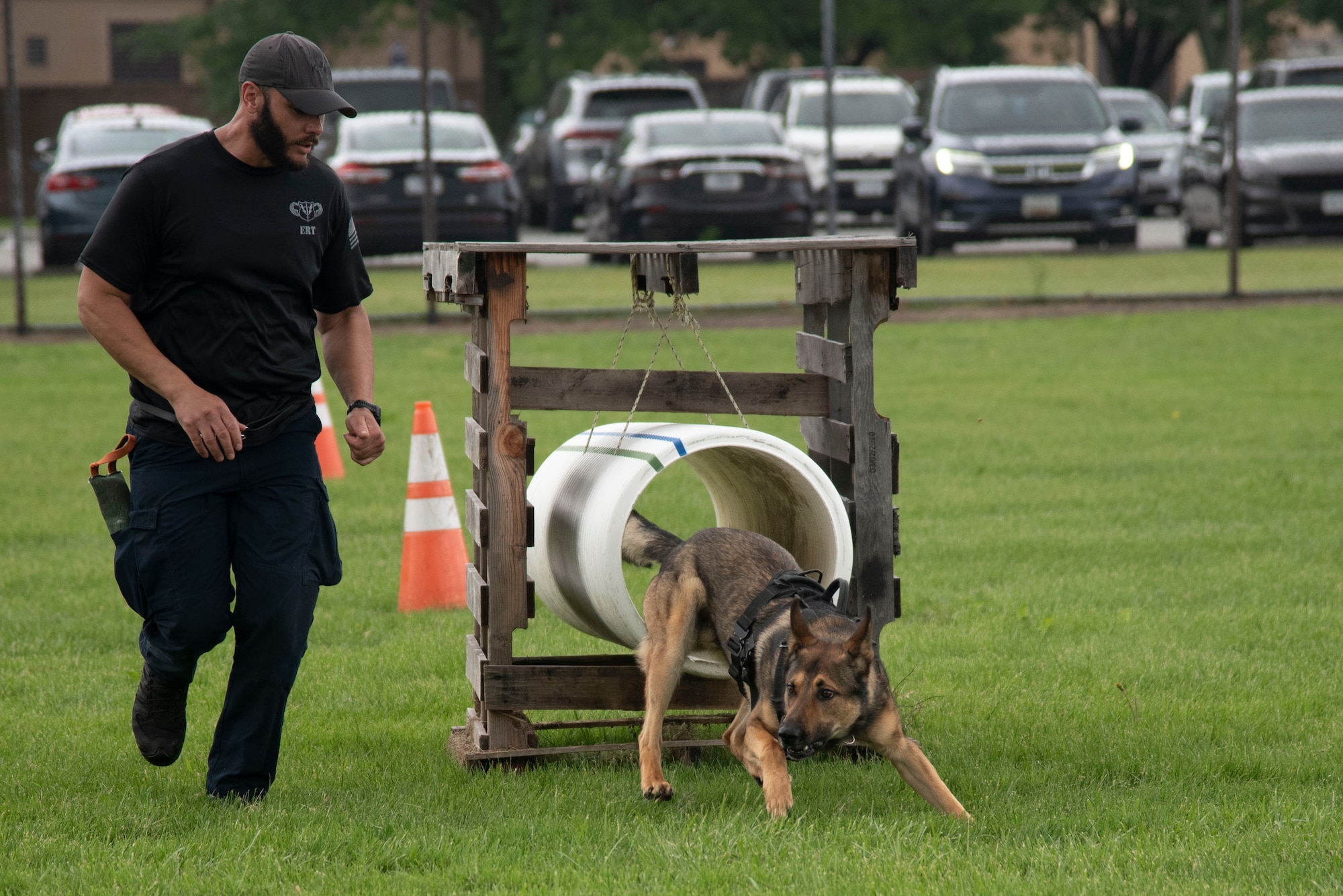 Tulio Quevedo, City of Hyattsville Police Department working dog handler, leads his dog, Hugo, through the obstacle course during the Capitol K-9 Trials at Joint Base Andrews, Md., May 14, 2025. The trials were part of National Police Week, which honors fallen officers and the service and sacrifice of law enforcement. (U.S. Air Force photo by Patrick Griffith)