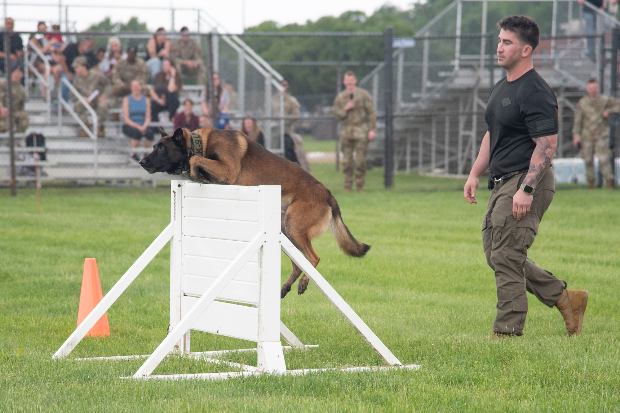 Ryan Maddox, Delaware Department of Corrections working dog handler, leads his dog, Fury, through the obstacle course at the Capitol K-9 Trials at Joint Base Andrews, Md., May 14, 2025. The event was one of many held on base in observance of National Police Week, which pays tribute to fallen military and civilian police officers. (U.S. Air Force photo by Patrick Griffith)