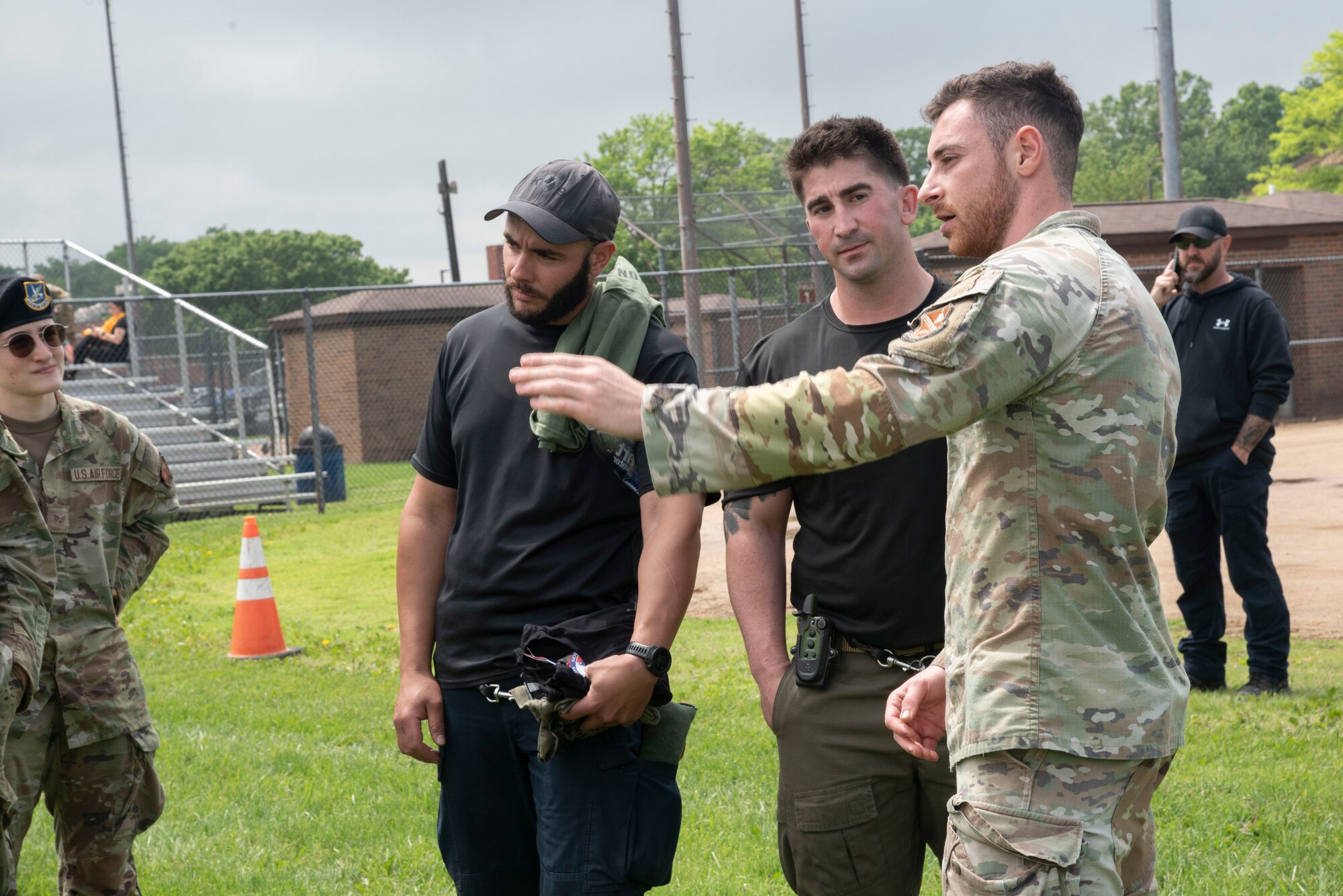 U.S. Air Force Senior Airman Jonathan J. Ayub, right, 316th Security Support Squadron, outlines the patrol demonstration procedures for working dog handlers participating in the Capitol K-9 Trials at Joint Base Andrews, Md., May 14, 2025. The trials was a joint event with police departments from the City of Hyattsville and Delaware Department of Corrections for National Police Week. (U.S. Air Force photo by Patrick Griffith)
