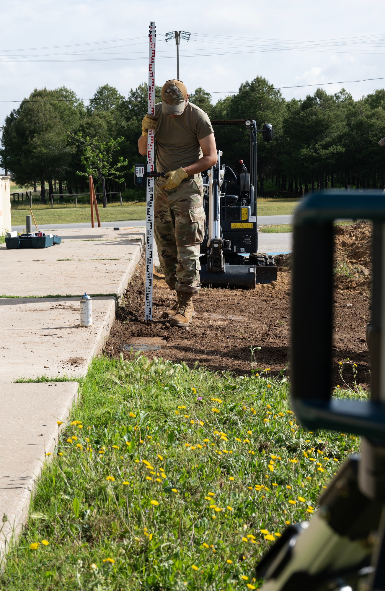 Senior Airman Kyu Wintersteen, 446th Civil Engineer Squadron pavement and construction equipment, checks the level of the ground at Moron Air Base, Spain, on May 6, 2025.