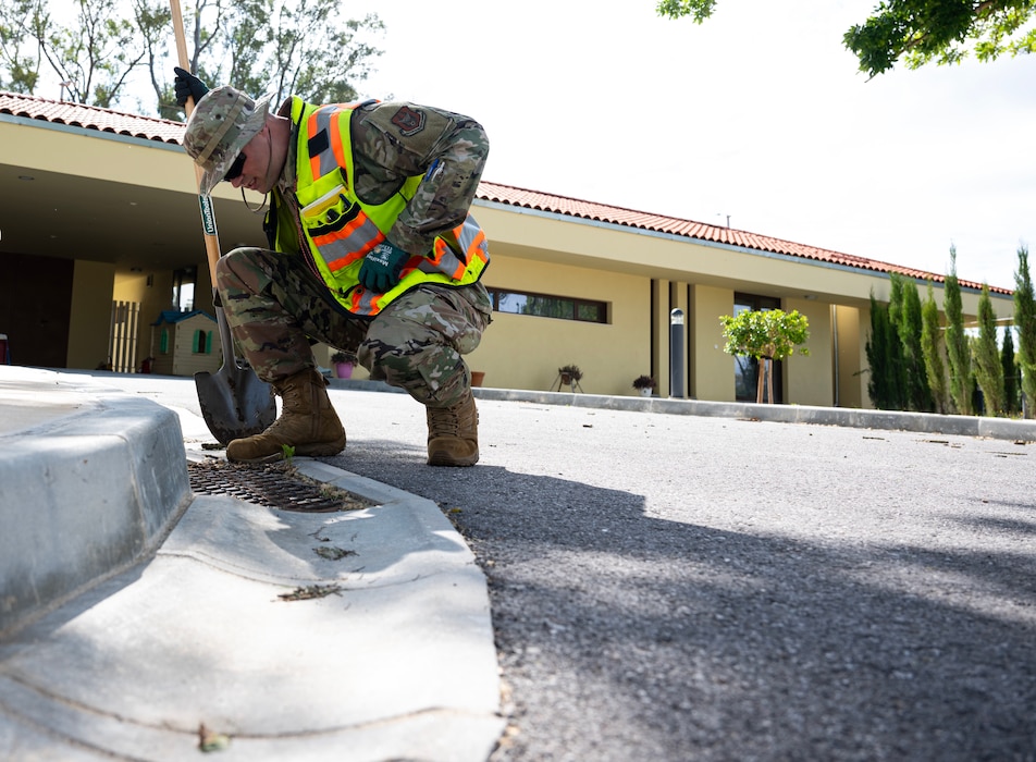 Staff Sgt. Michael Chiniquy, 446th Civil Engineer Squadron engineering assistant, checks for potential drainage issues at Moron Air Base, Spain, on May 6, 2025.