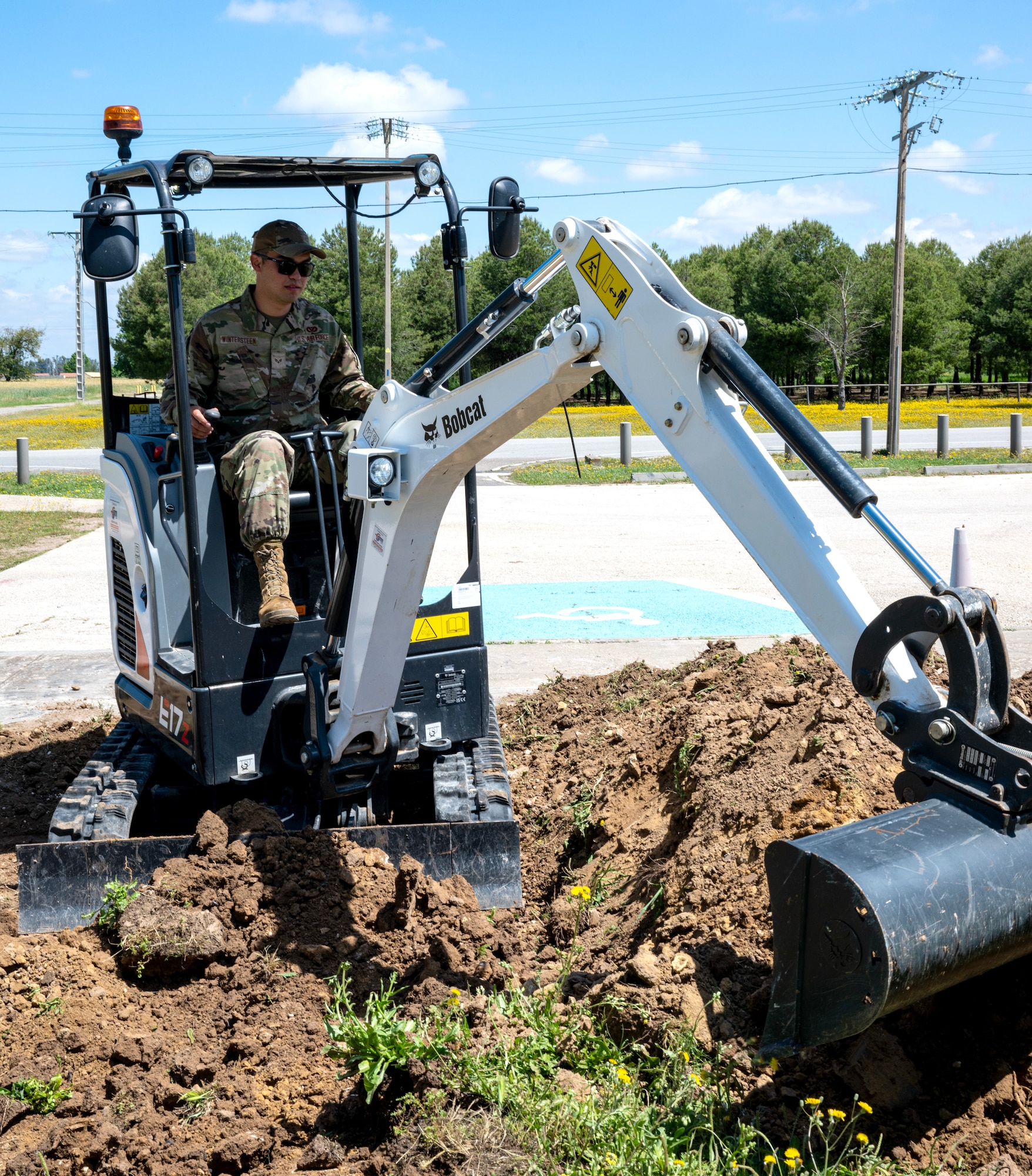 Senior Airman Kyu Wintersteen, 446th Civil Engineer Squadron pavement and construction equipment journeyman, moves dirt to lay groundwork for a ramp at Moron Air Base, Spain, on May 6, 2025.