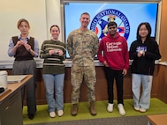 LTC Michael Antonas of the Ohio Army National Guard presented a challenge coin Feb. 26 to four Hacking for Defense students at Carnegie Mellon University in Pittsburgh for their work on a project to help recruiting efforts.