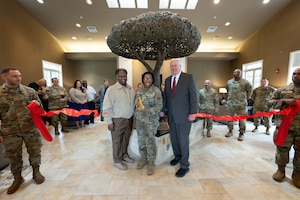 Horace L. Larry, director of Air Force services for Headquarters Air Force, Lt. Col. Crystal A. Glaster, Air Force Mortuary Affairs Operations deputy commander and Dave Coker, Fisher House Foundation, president, cut the ribbon for the Freedom Oak at the Mediation Pavilion on the Fisher House for the Families of the Fallen campus at Dover Air Force Base, Delaware, May 23, 2025.