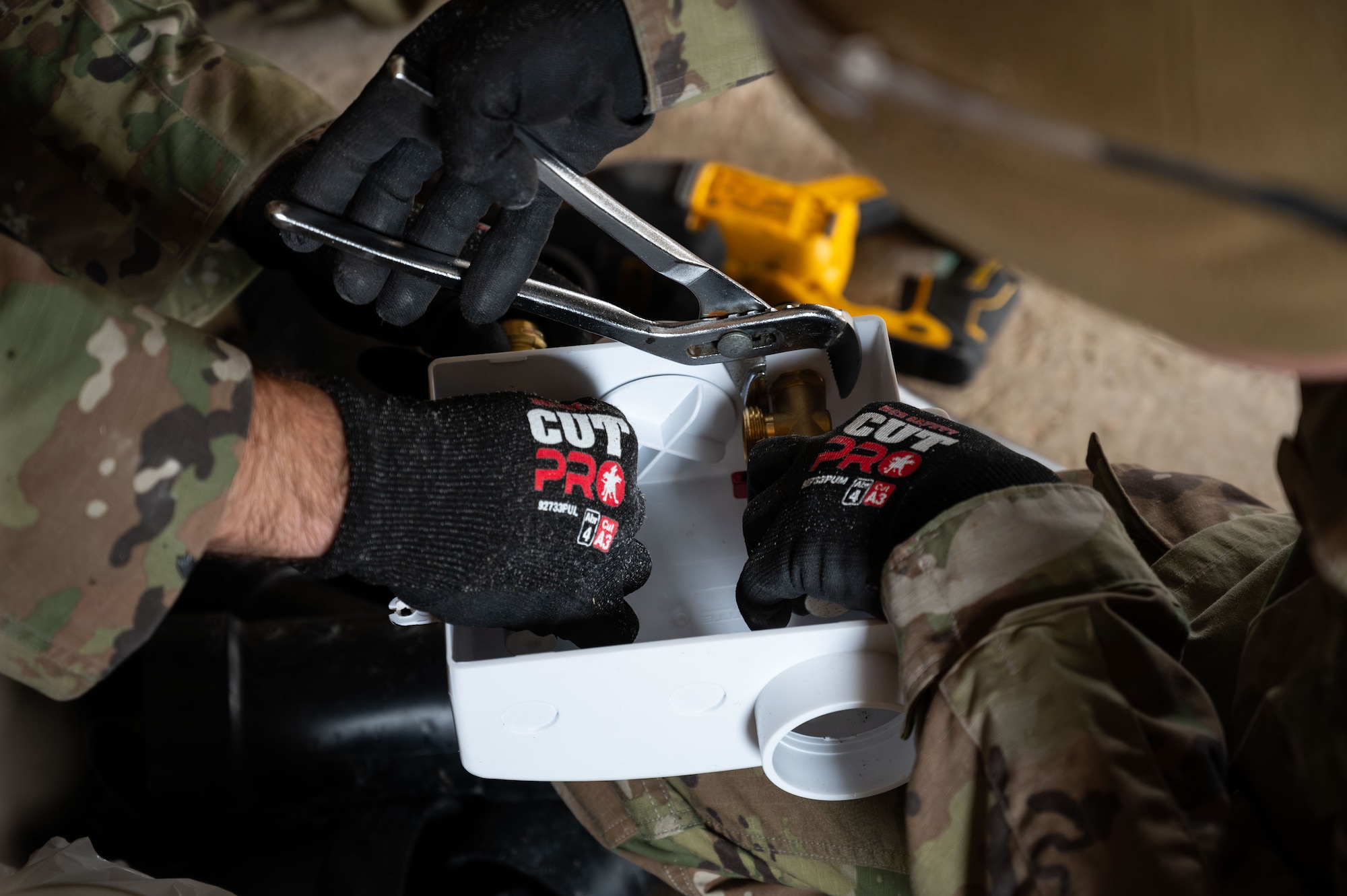 Tech. Sgt. Conner Smith and Tech. Sgt. Ryan Speicher, 131st Civil Engineer Squadron (CES) heavy equipment operator journeymen, tighten copper piping fittings during a deployment for training in Seward, Alaska, April 25, 2025. 131st CES Airmen deployed to Alaska as part of an ongoing partnership with the Seward Military Resort, which allows military units to train while updating structures and infrastructure on location. (U.S. Air National Guard photo by Senior Airman Kelly C. Ferguson)