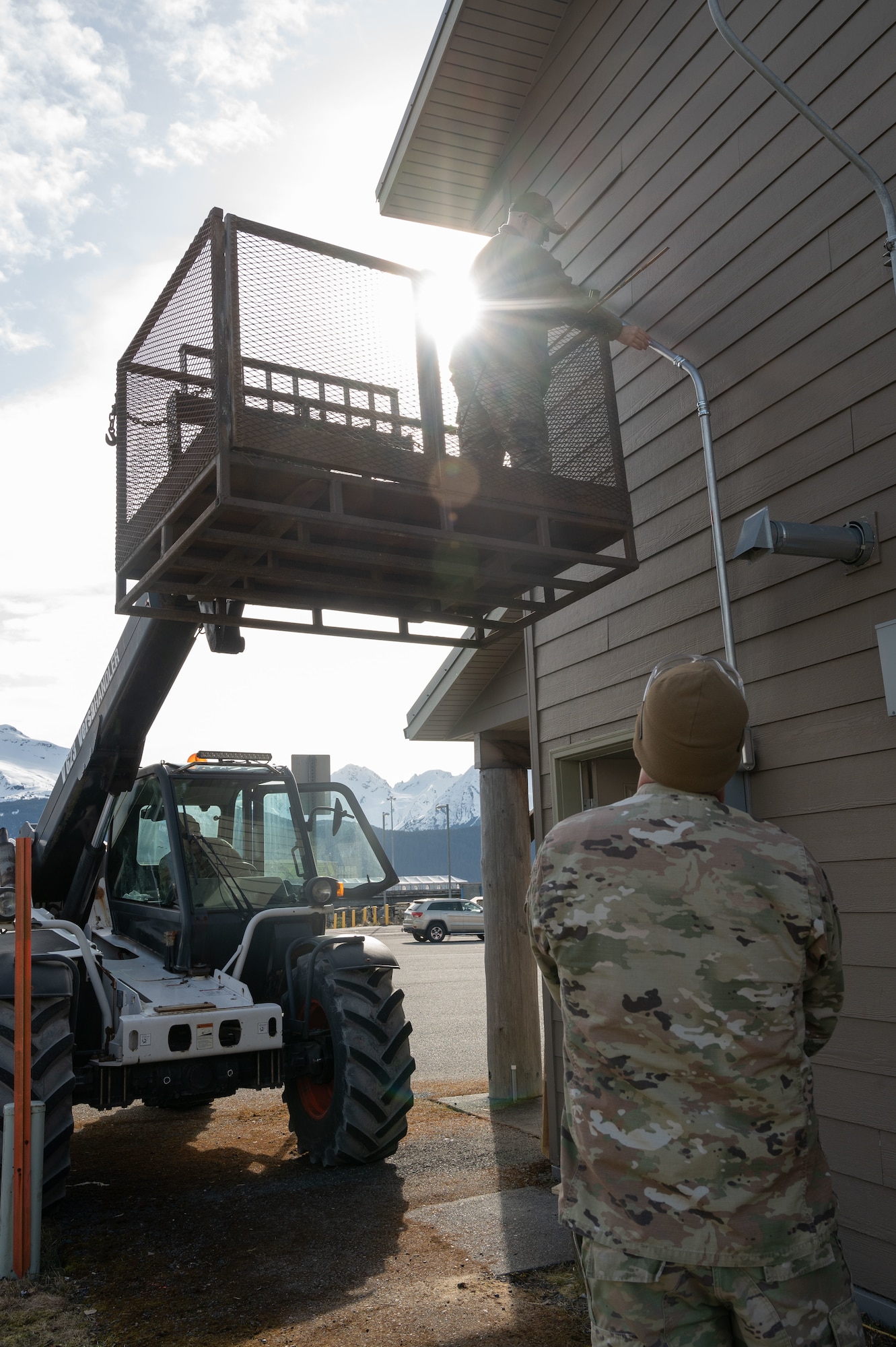 Chief Master Sgt. Mark Salter, 131st Civil Engineer Squadron (CES) civil engineer chief, reinforces a conduit while standing on a lift during a deployment for training in Seward, Alaska, April 24, 2025. 131st CES Airmen deployed to Alaska as part of an ongoing partnership with the Seward Military Resort, which allows military units to train while updating structures and infrastructure on location. (U.S. Air National Guard photo by Senior Airman Kelly C. Ferguson)