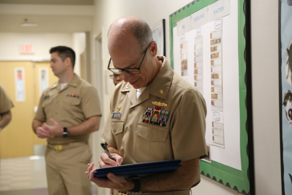 On May 9, Capt. Aaron D. Werbel, commanding officer of Navy Medicine Readiness and Training Command Lemoore signed Hospital Corpsman Third (HM3) Class Dominic T. Morgan and HM3 Gerwin Riel M. Quemquem's on-the-spot U.S. Navy and Marine Corps Achievement Medal (NAM) certificates, also known as a ‘Spot NAM’.  This award highlights a specific achievement or impact shortly after the event occurred. (DoD Photo by Elaine Heirigs/released)