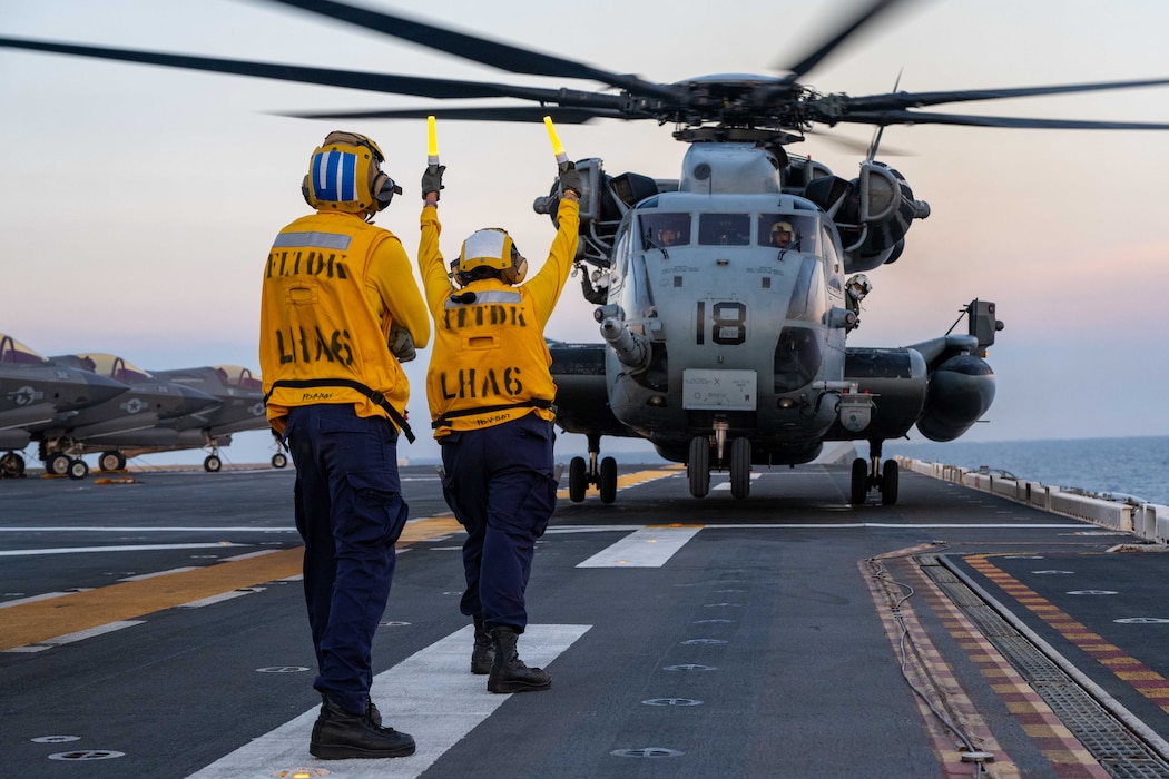 Aviation Boatswain’s Mate (Handling) 3rd Class Lauren Bryan, from Victorville, California, right, and Aviation Boatswain’s Mate (Handling) Airman, JuanDiego Navarro, left, from Puerto Rico, both assigned to the forward-deployed amphibious assault ship USS America (LHA 6), direct a CH-53E Super Stallion helicopter, from the 31st Marine Expeditionary Unit (MEU) Air Combat Element (ACE) to take off from the flight deck while conducting flight operations in the Philippine Sea, May 22. The America, lead ship of the America Amphibious Ready Group, is operating in the U.S. 7th Fleet area of operations. U.S. 7th Fleet is the U.S. Navy’s largest forward-deployed numbered fleet, and routinely interacts and operates with allies and partners in preserving a free and open Indo-Pacific region. (U.S. Navy photo by Mass Communication 3rd Class Kenneth Melseth)