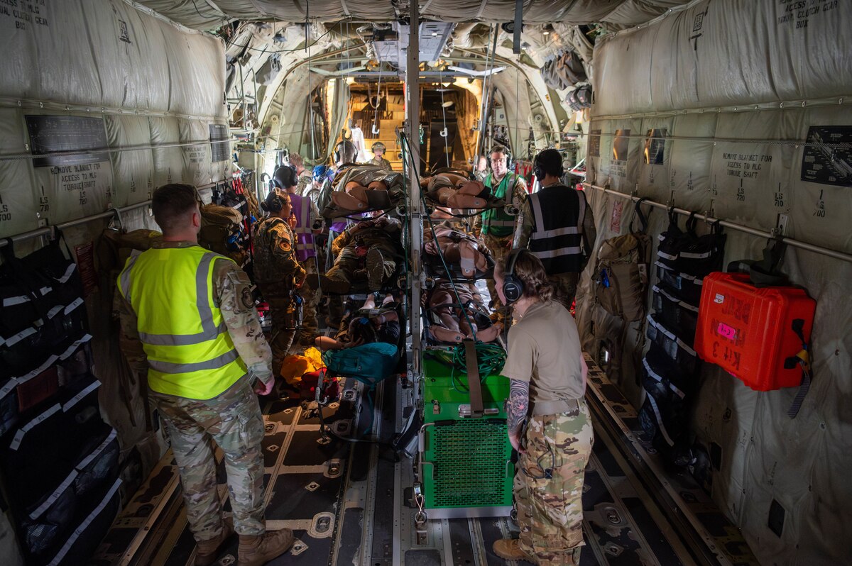 Airmen from the 375th Aeromedical Evacuation Squadron perform in-flight triage procedures on simulated casualties during a Theater Aeromedical Evacuation System exercise at Scott Air Force Base