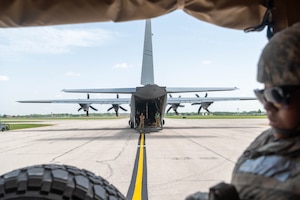 Airmen stand inside the open cargo bay of a C-130 Hercules during a Theater Aeromedical Evacuation System exercise at Scott Air Force Base
