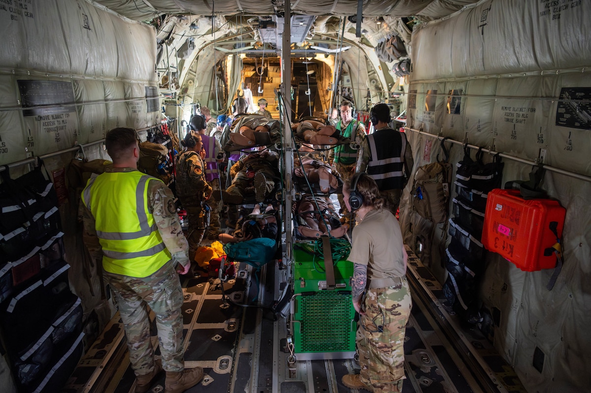 Airmen from the 375th Aeromedical Evacuation Squadron perform in-flight triage procedures on simulated casualties during a Theater Aeromedical Evacuation System exercise at Scott Air Force Base