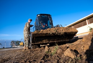 Master Sgt. Matthew Smith, 446th Civil Engineer Squadron pavement and construction equipment NCOIC, provides guidance for moving dirt to an Airman at Moron Air Base, Spain, on May 6, 2025.